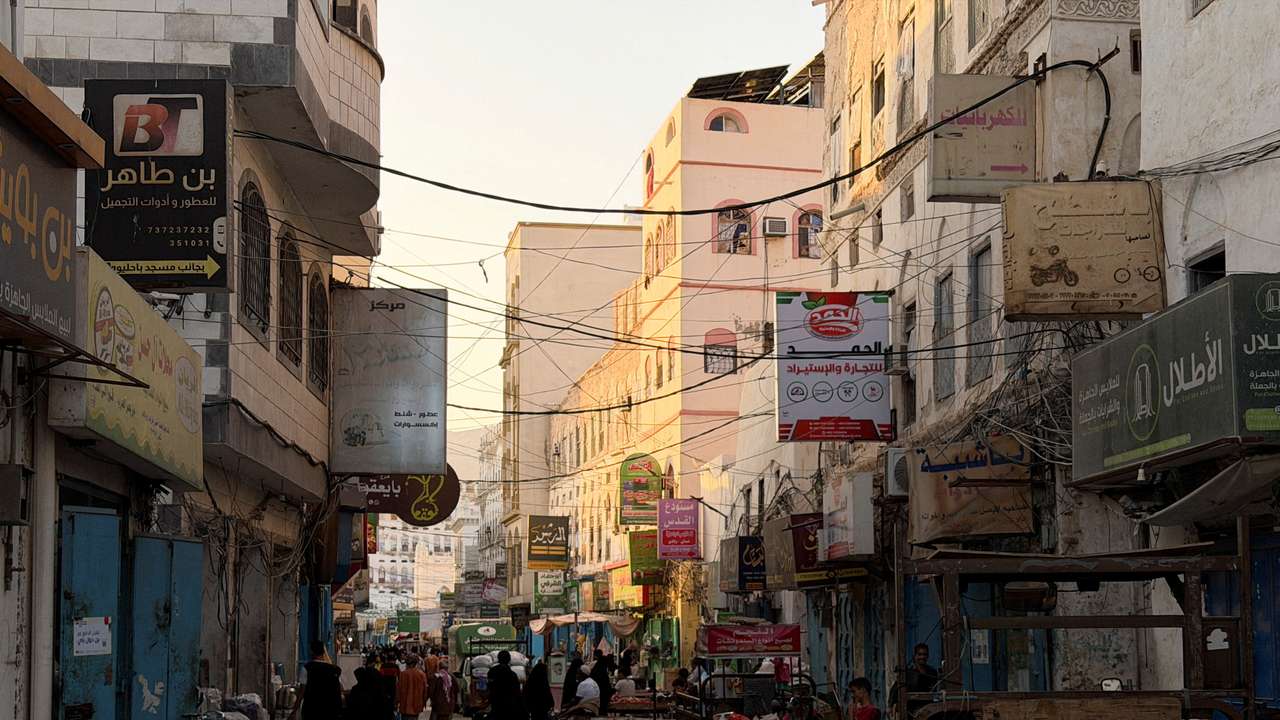 FILE PHOTO: People walk through a traditional market in the port city of Mukalla