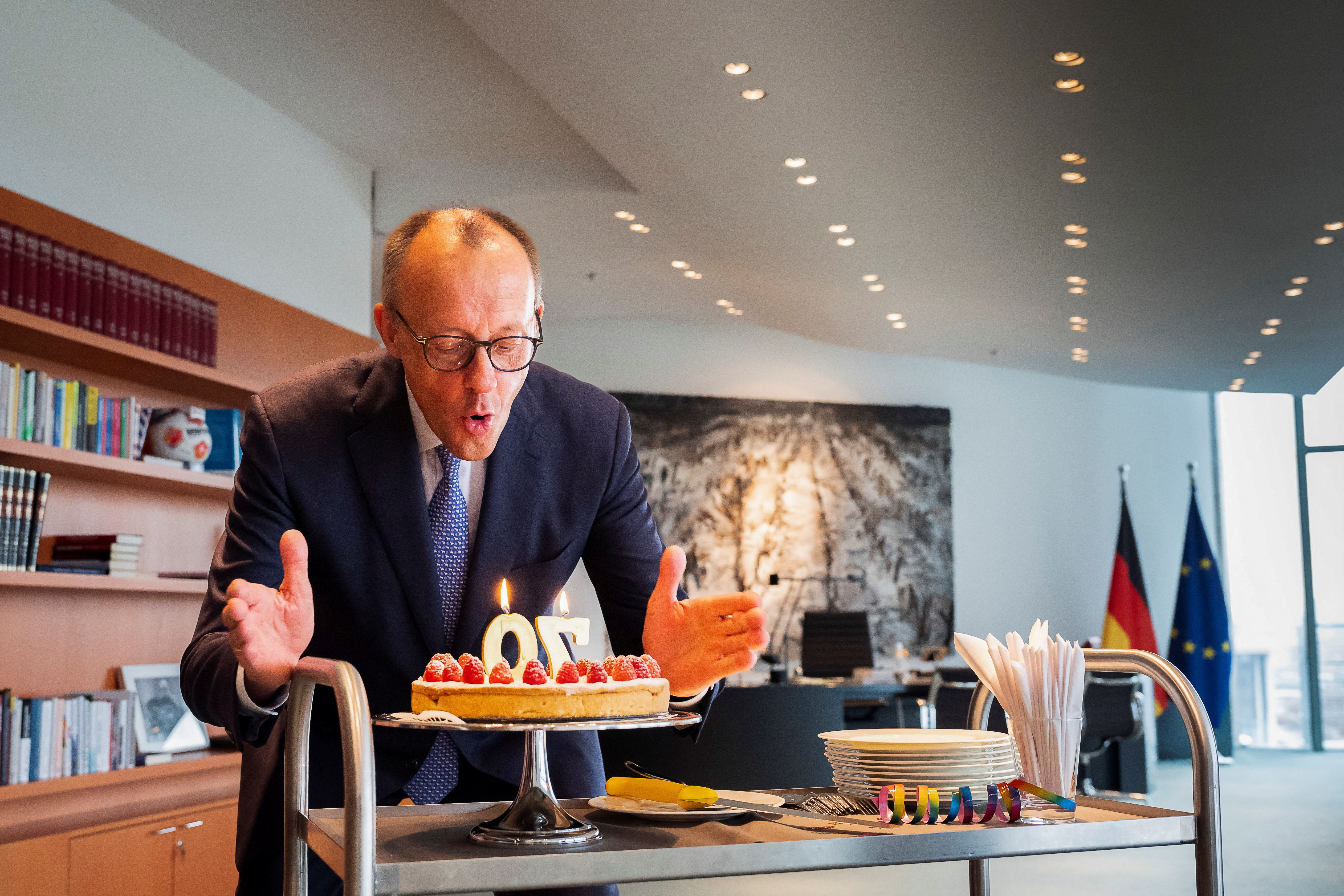 German Chancellor Merz blows out some candles on the occasion of his 70th birthday in Berlin