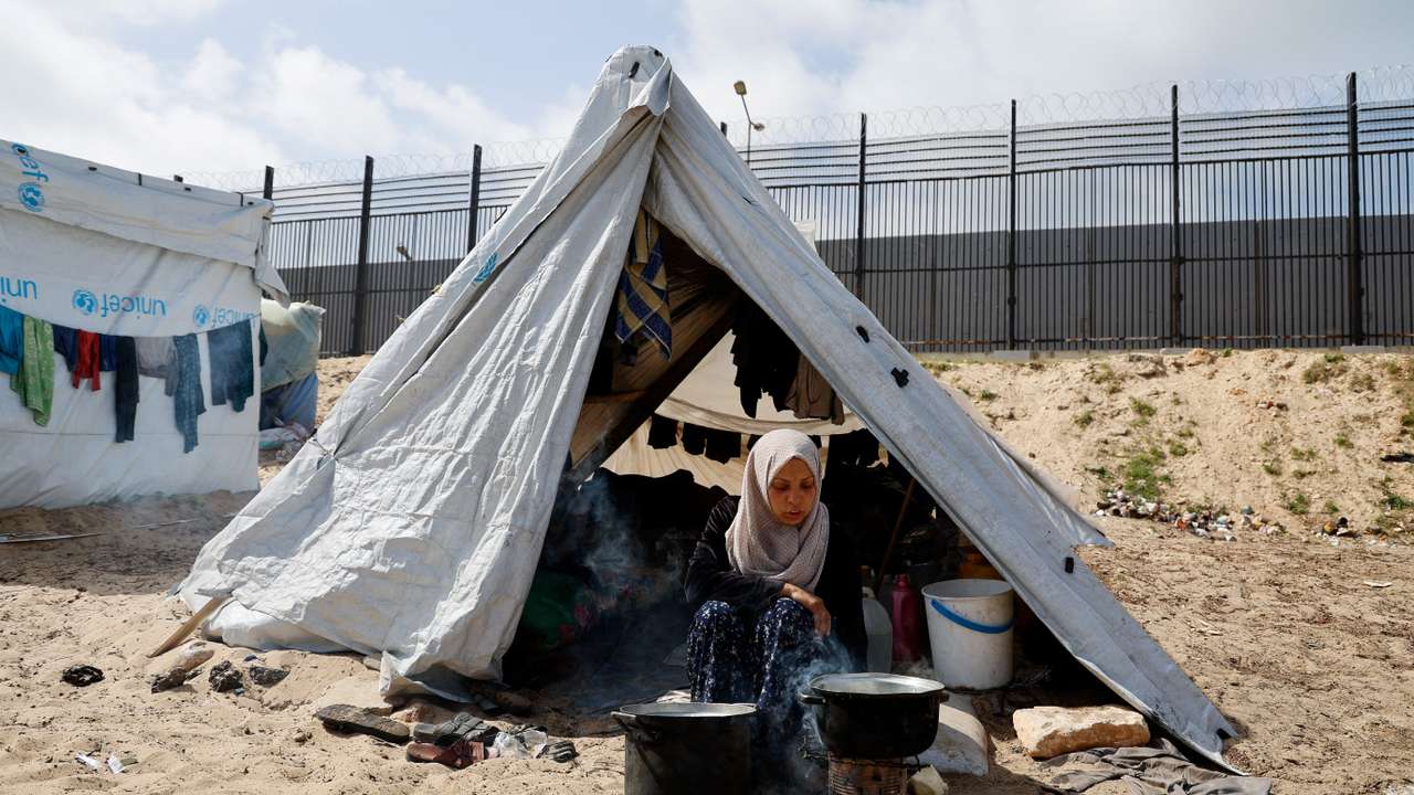 Displaced Palestinians, who fled their houses due to Israeli strikes, shelter at a tent camp, in Rafah