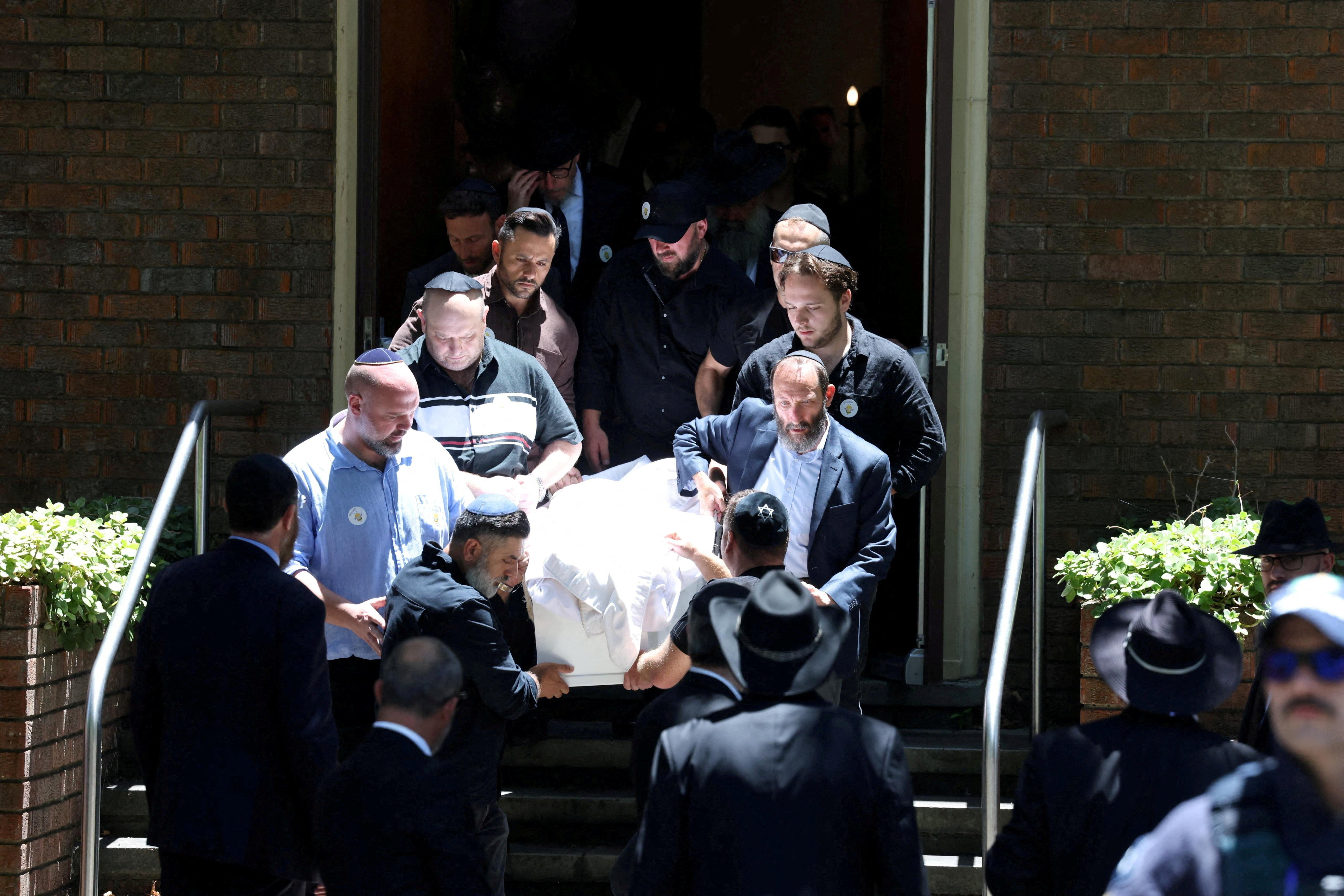 Mourners carry the casket of 10-year-old Matilda the youngest victim of a mass shooting at Australia's Bondi Beach at Chevra Kadisha in Sydney