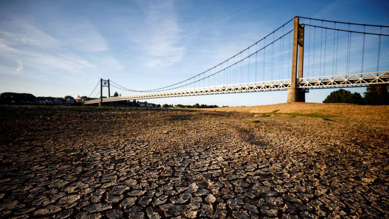 FILE PHOTO: Cracked and dry earth is seen in the wide riverbed of the Loire River in Ancenis-Saint-Gereon