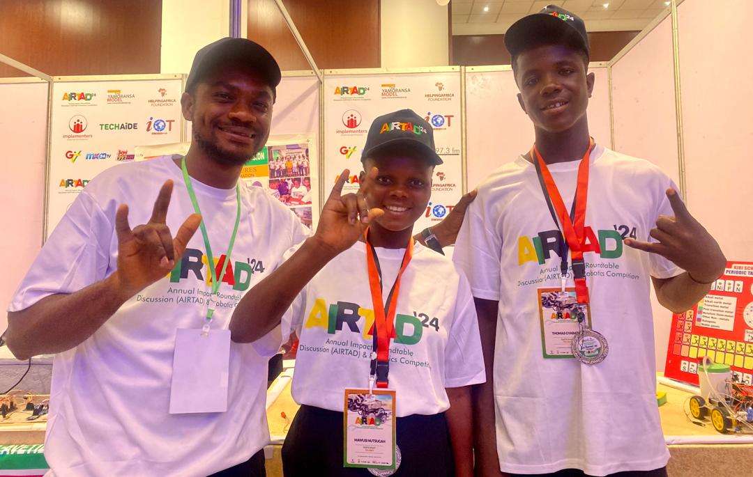 Mawuli Nutsugah, Thomas Djabatey and their interpreter at the Robotics Competition in Accra.