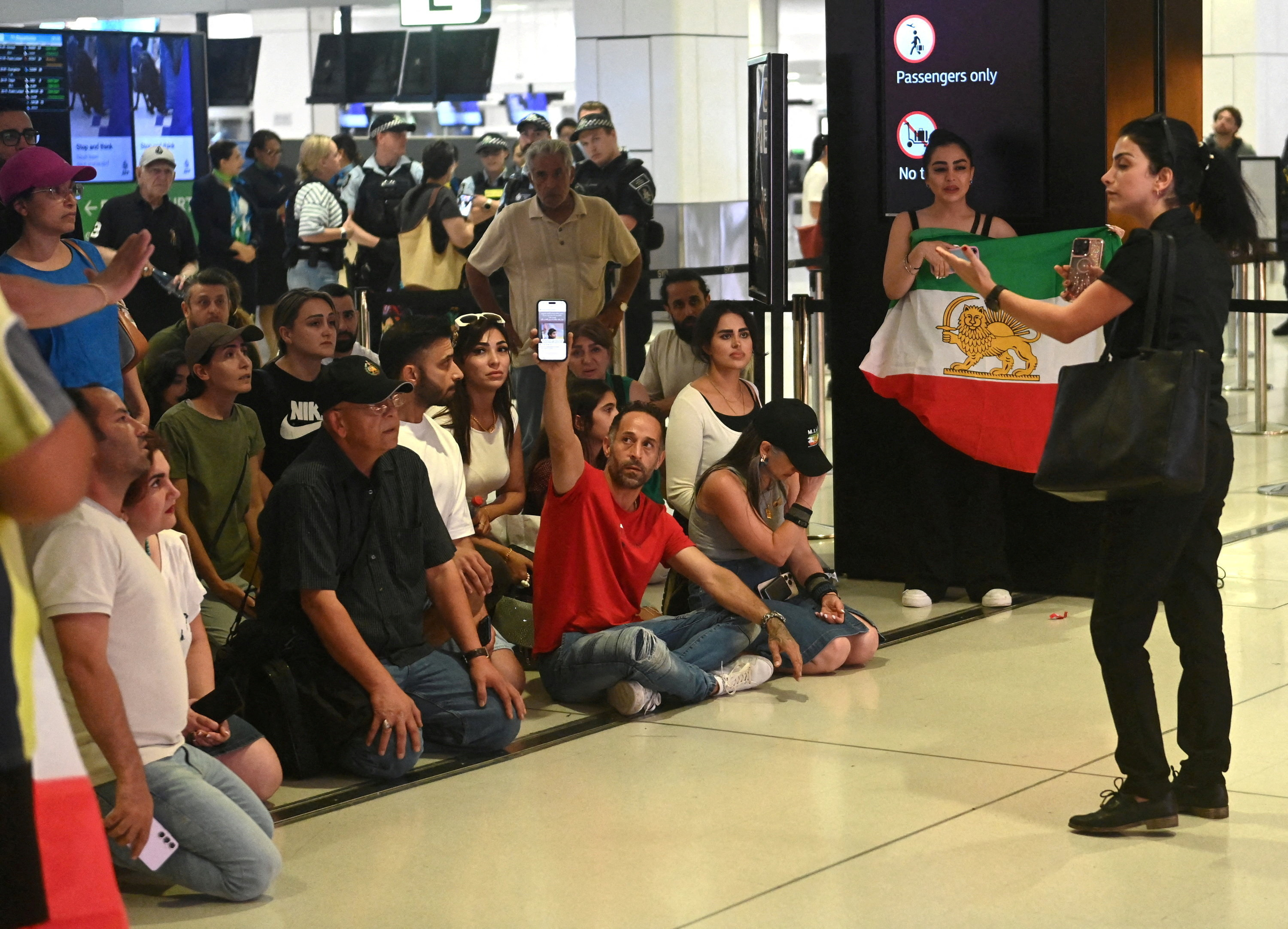 Supporters of the Iranian women's soccer team gather at Sydney Airport