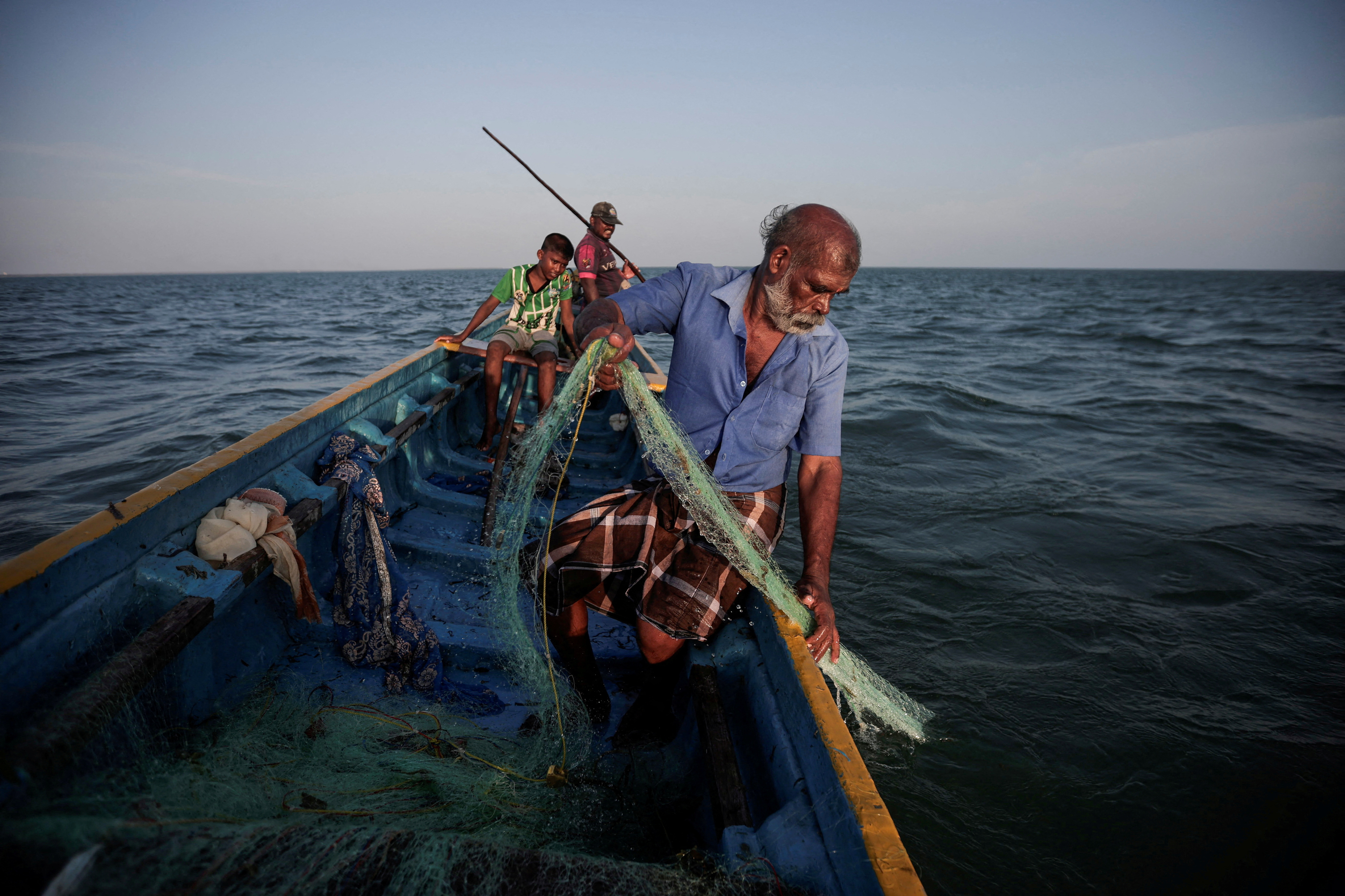 Fisherman Parasamy Thanabalasingam catches fish in the waters of the Indian Ocean, off the coast of Jaffna