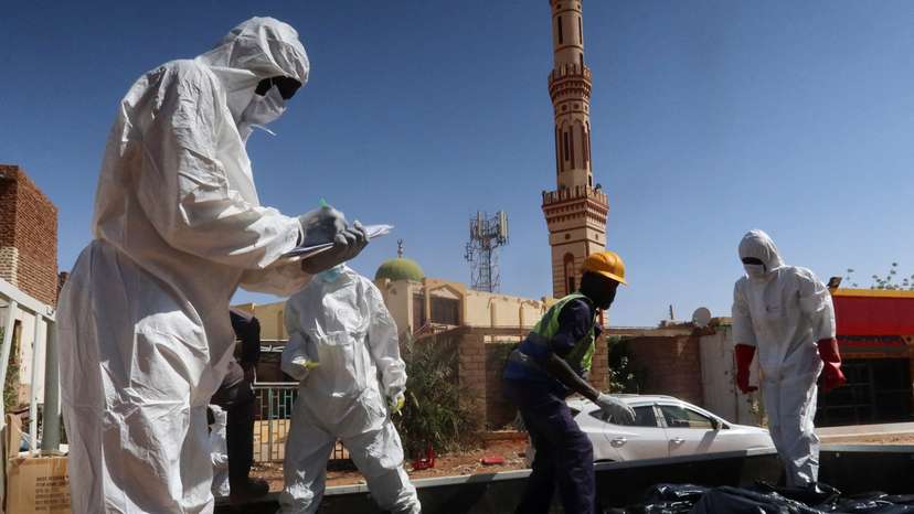 Sudanese Red Crescent volunteers recover bodies from a well at the Sharg Elnil area in the state of Khartoum