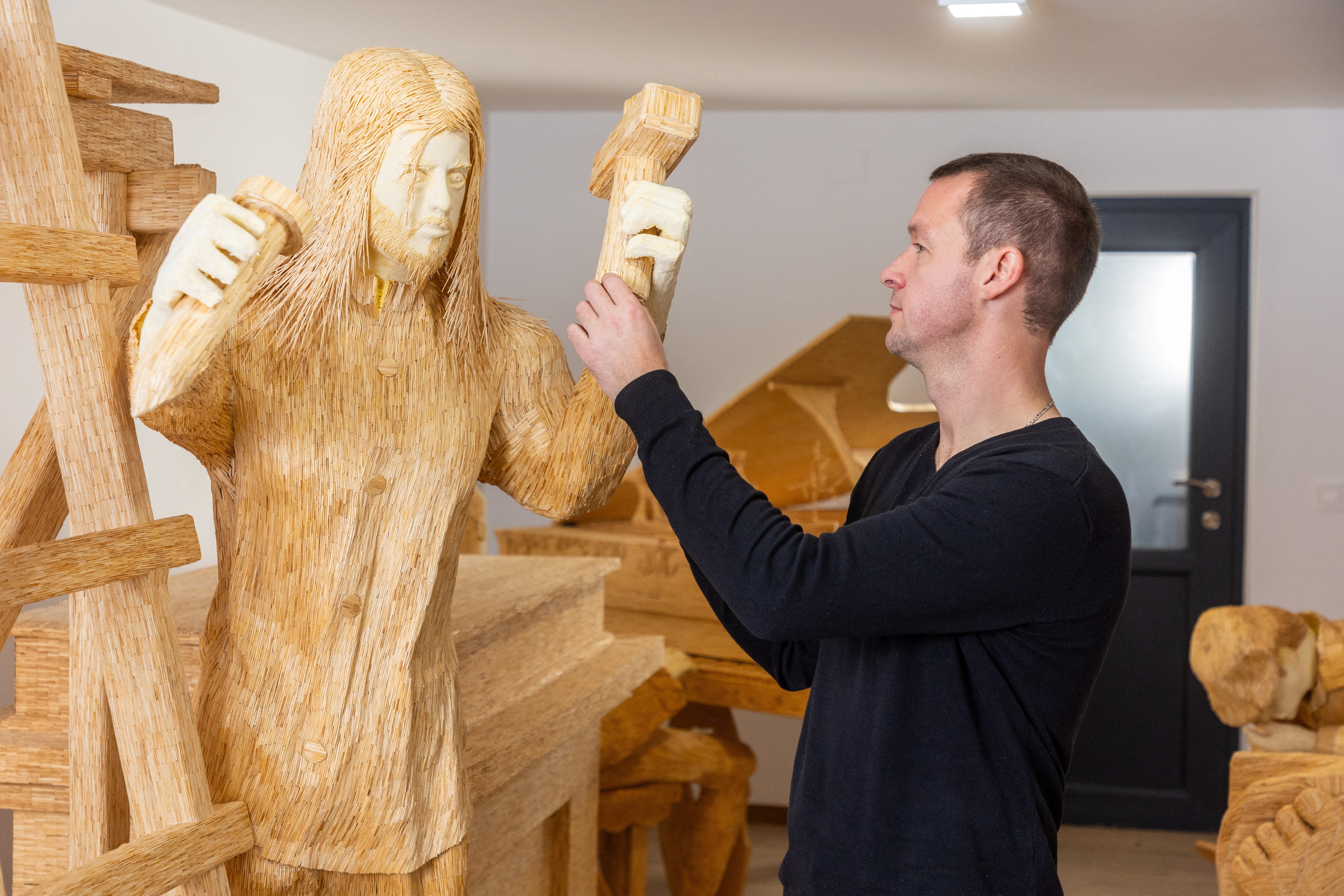 Artist Horvat works on sculpture made of matches in Domasinec