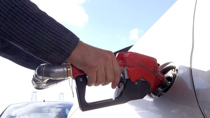 Man refuels his car at a petrol station in Tehran