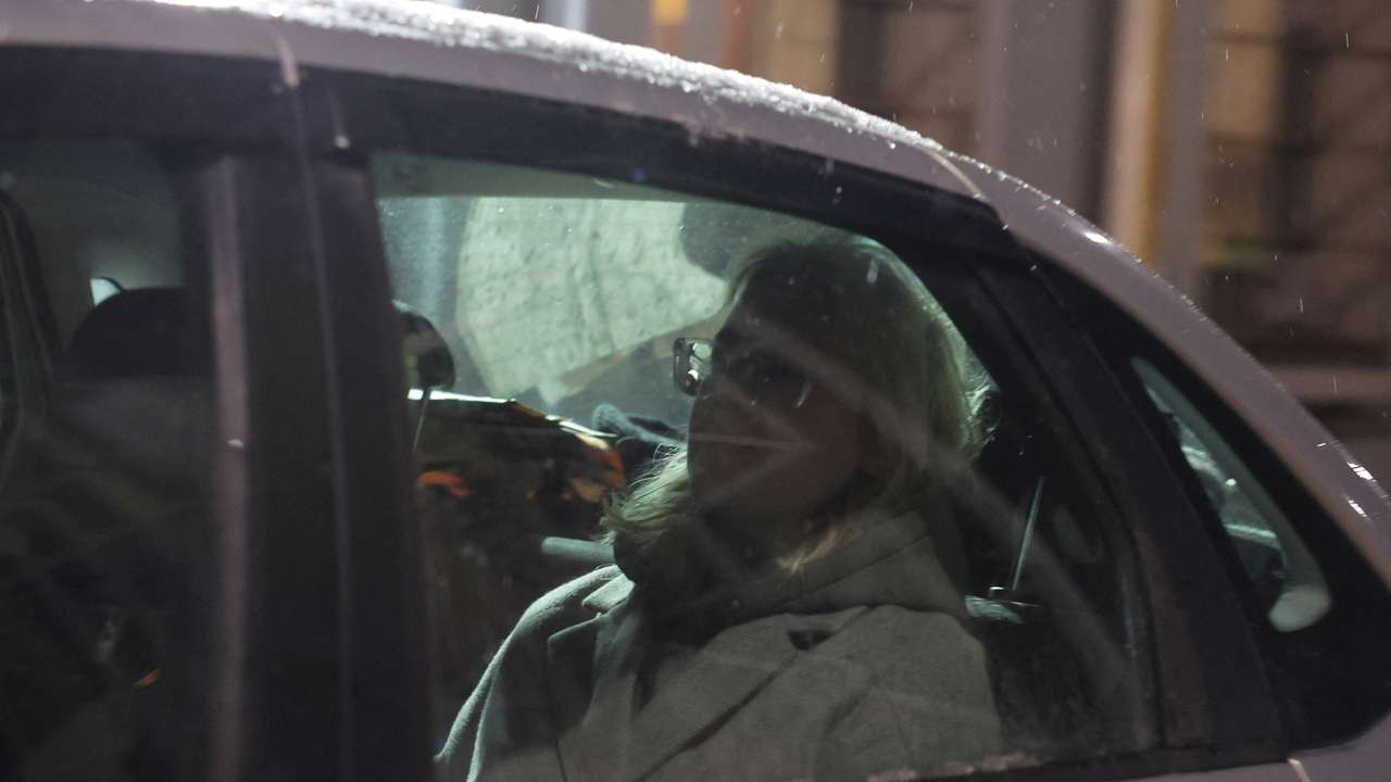 Russian musician Loginova is escorted out of a temporary detention facility