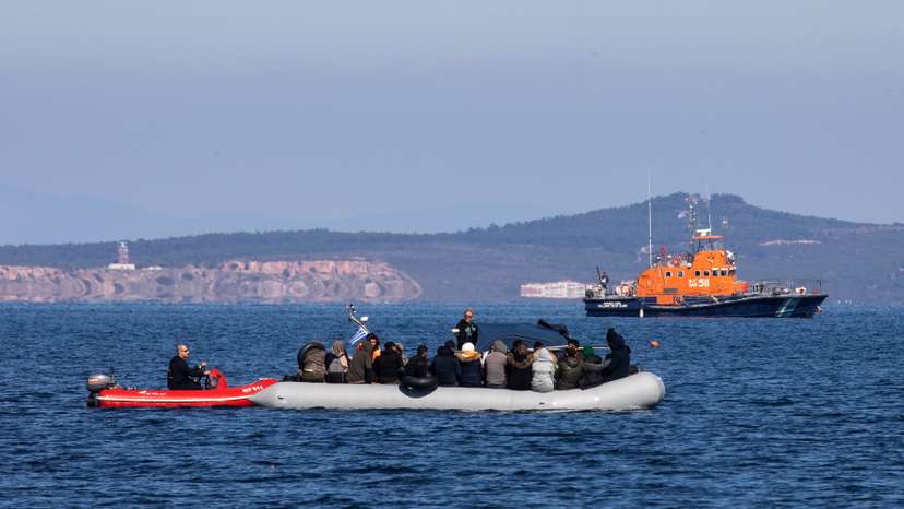 Migrants on a dinghy with a damaged engine are helped by coast guard rescuers to reach the port of Thermi, as they cross part of the Aegean Sea from Turkey to the island of Lesbos