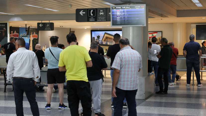 People stand at Beirut-Rafic Hariri International Airport, in Beirut
