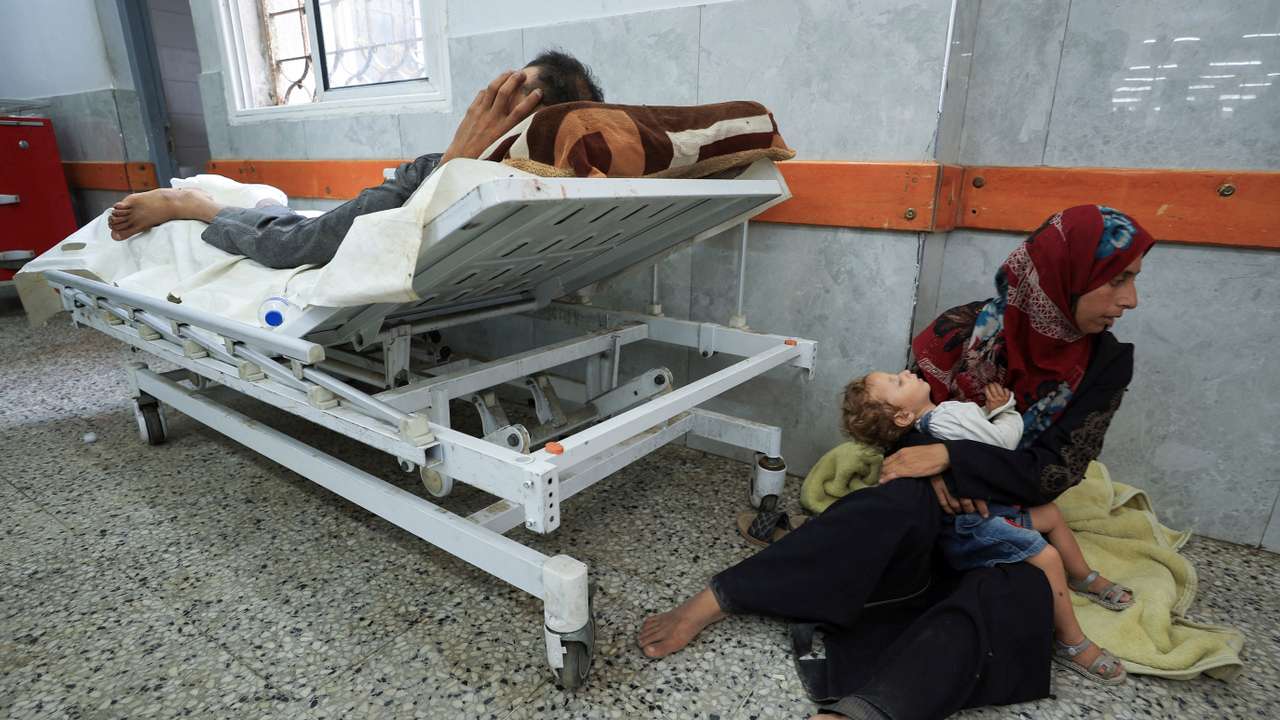 A Palestinian wounded in Israeli fire near an aid distribution center in central Gaza, according to medics, lies at Al-Shifa hospital, in Gaza City