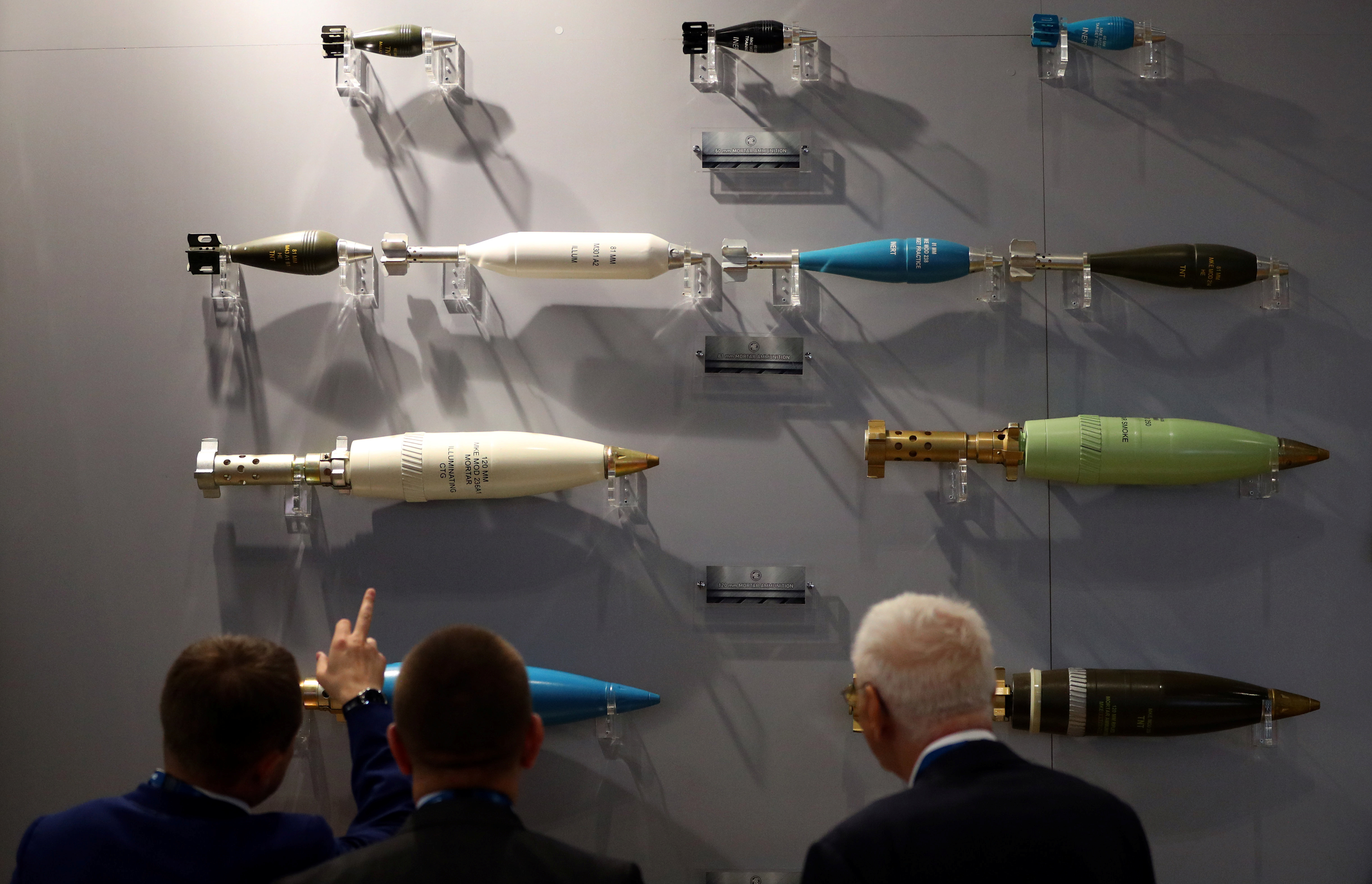 Visitors look at ammunition on display at the Defence and Security Equipment International trade show in London