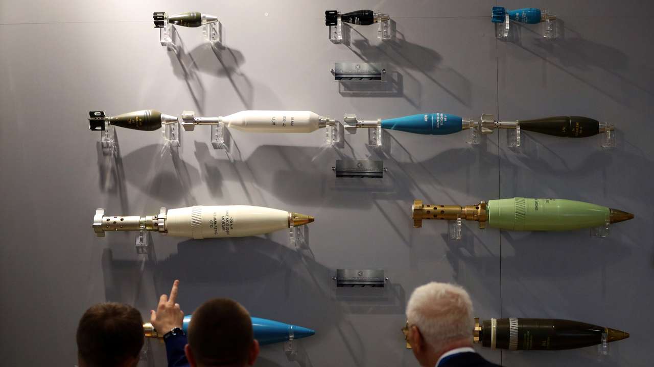 Visitors look at ammunition on display at the Defence and Security Equipment International trade show in London