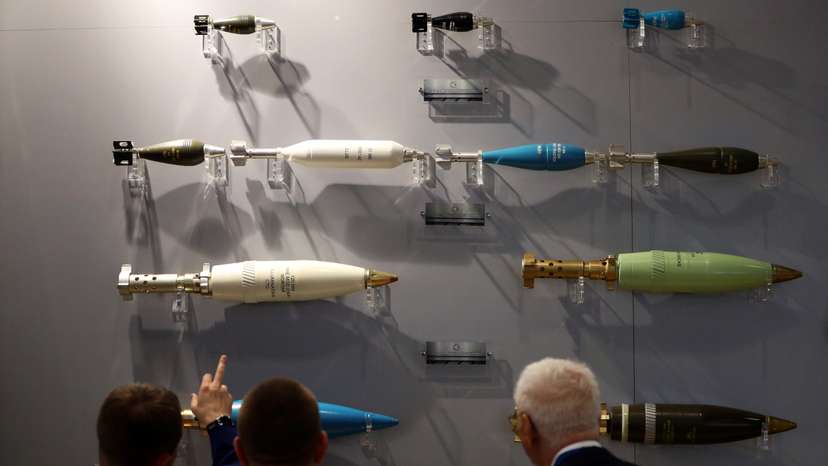 Visitors look at ammunition on display at the Defence and Security Equipment International trade show in London