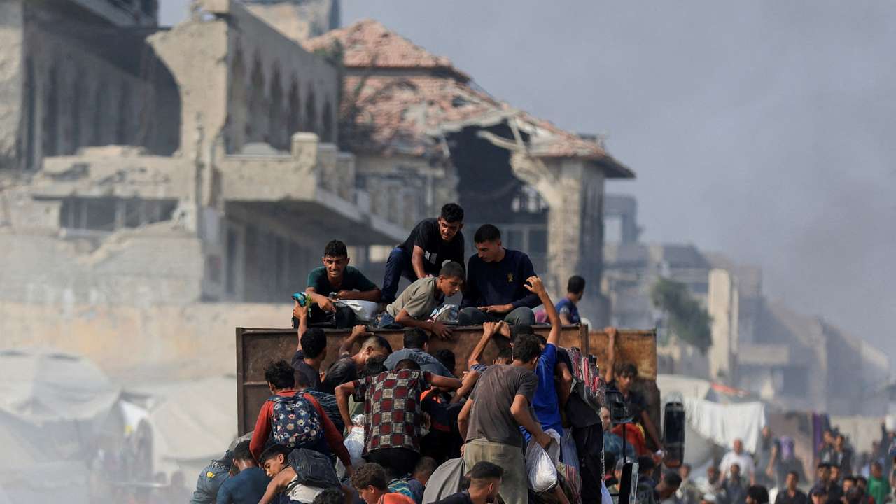 Palestinians seek aid supplies from trucks that entered Gaza through Israel, in Beit Lahia, in the northern Gaza Strip