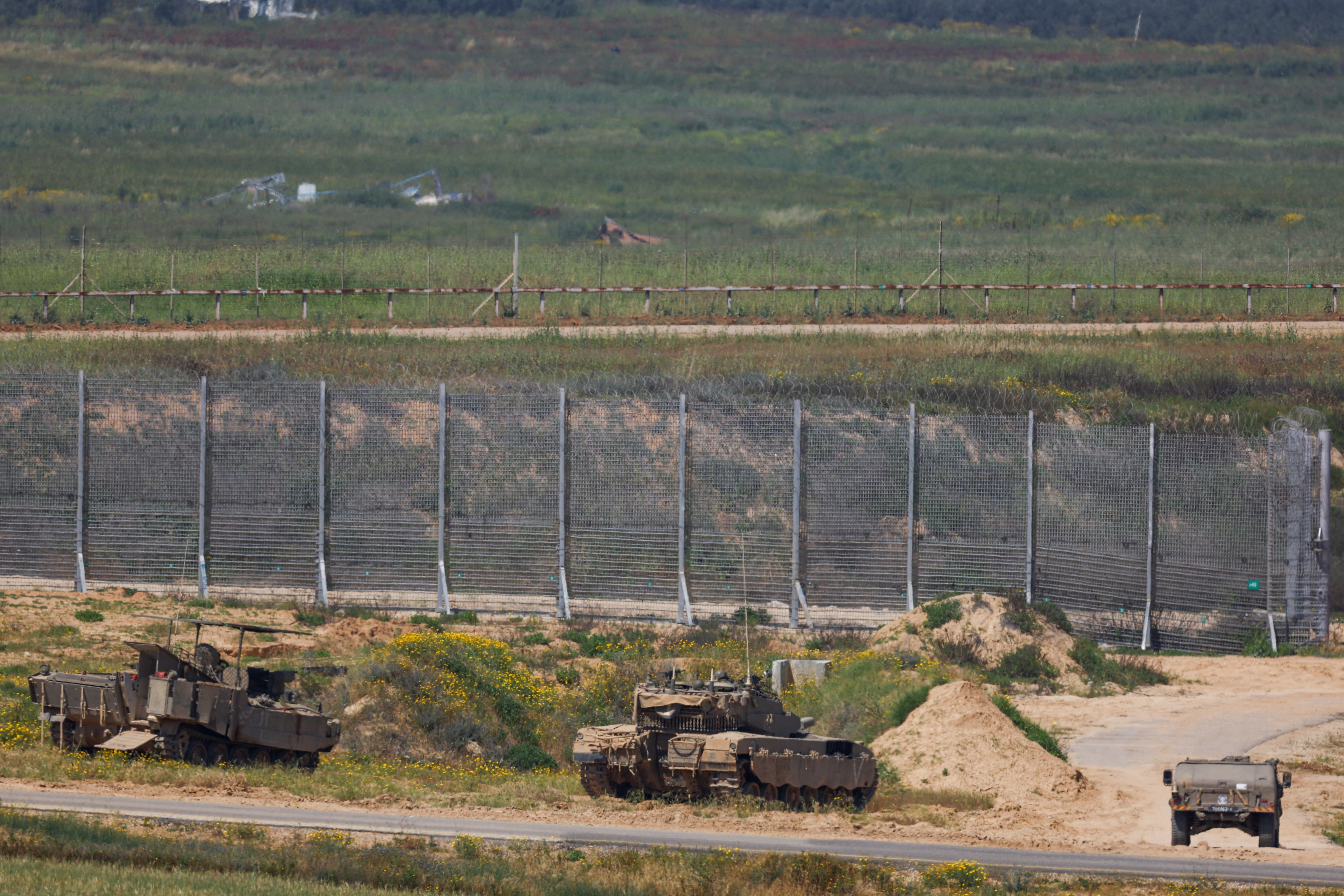 Israeli military vehicles hold position near the Israel-Gaza border