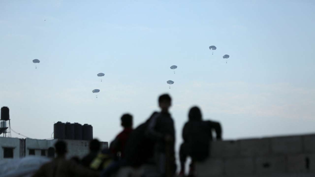 People watch as U.S. military carries out its first aid drop over Gaza, amid the ongoing the conflict between Israel and the Palestinian Islamist group Hamas, in Gaza City