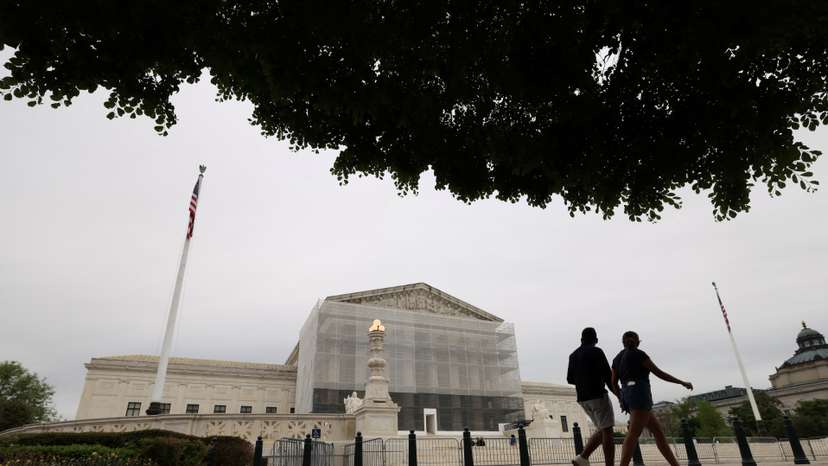 People walk by the U.S. Supreme Court in Washington