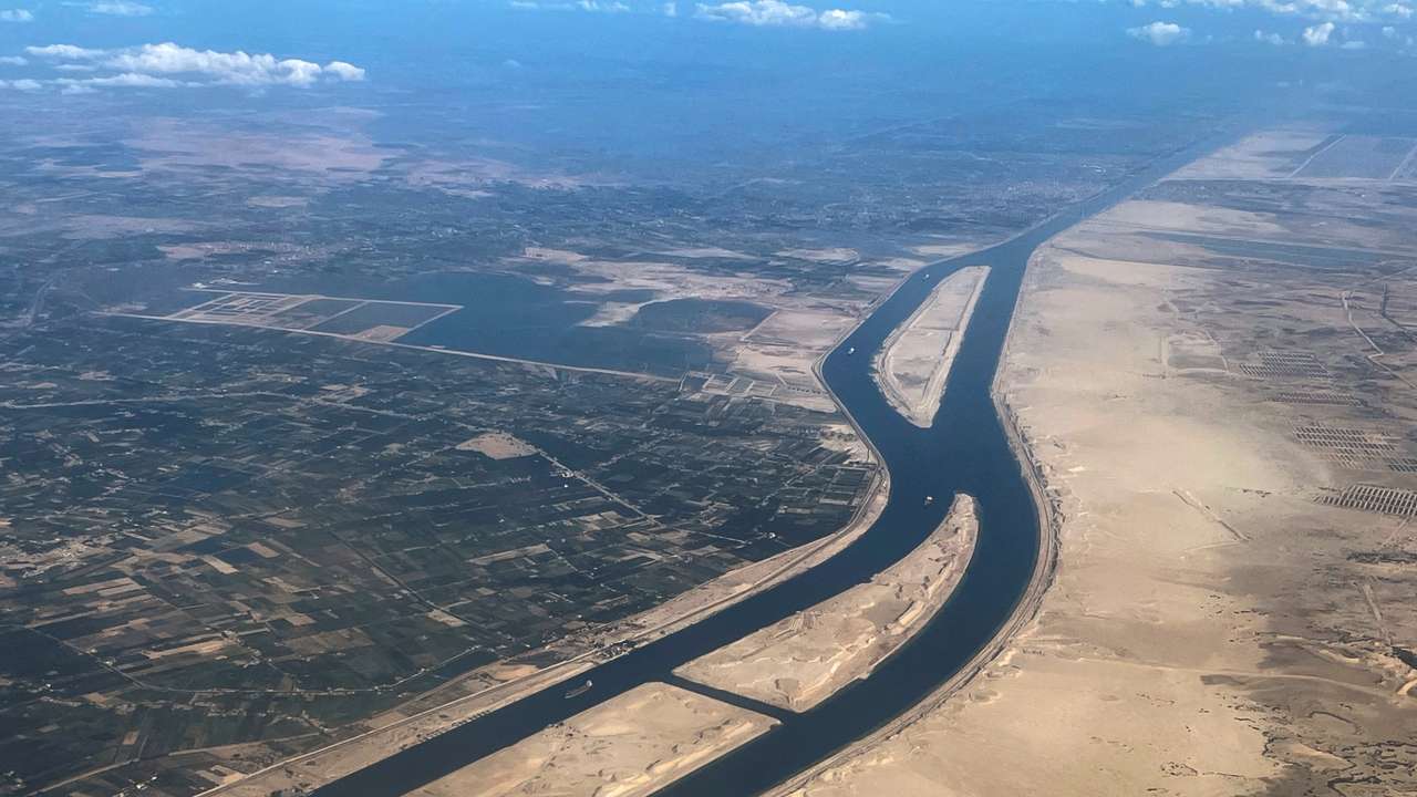 FILE PHOTO: Ships are seen from a plane window, passing through the Suez Canal