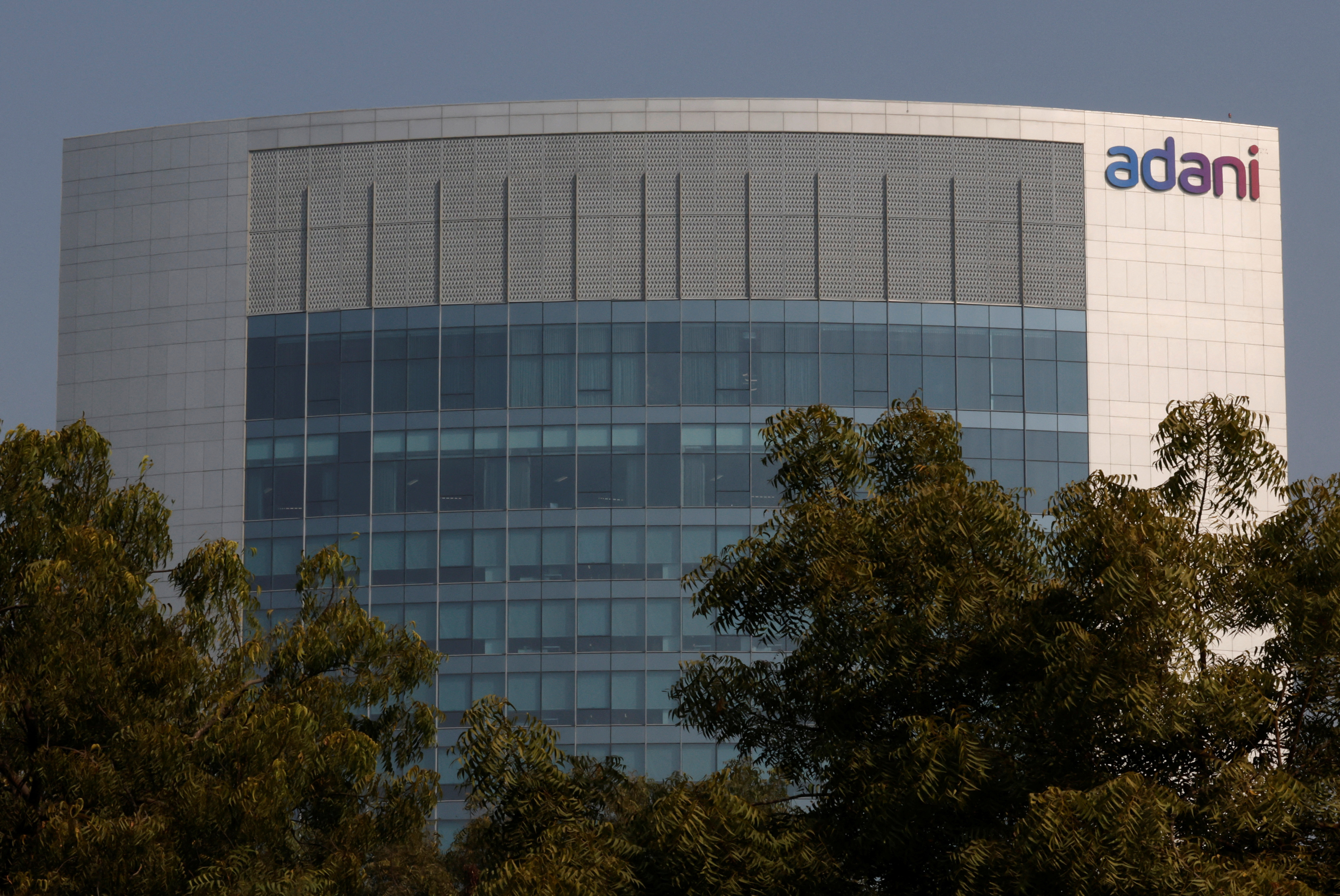 The logo of the Adani Group is seen on the facade of its Corporate House on the outskirts of Ahmedabad