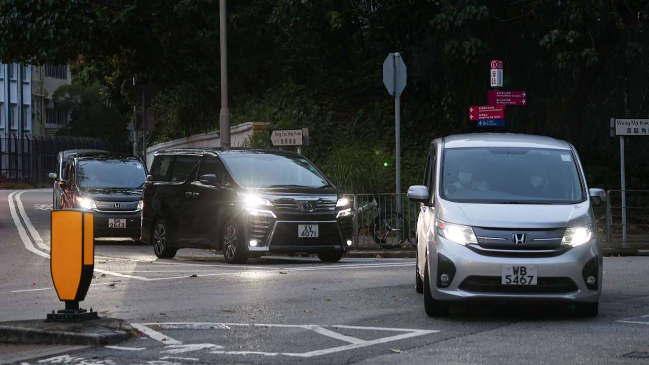 Vans believed to be carrying former Hong Kong lawmakers Kwok Ka-ki and Jeremy Tam leave from Stanley Prison, after serving four-year and two months sentences for conspiracy to commit subversion in a landmark national security case, in Hong Kong