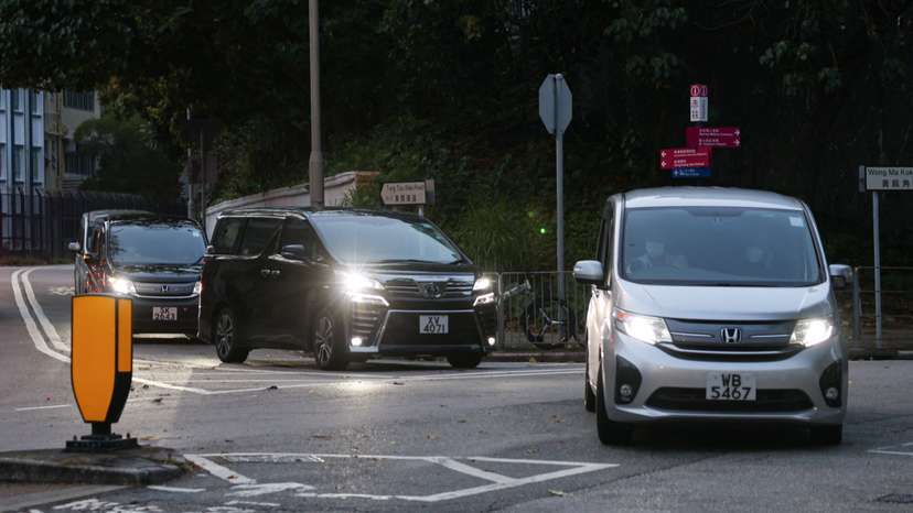 Vans believed to be carrying former Hong Kong lawmakers Kwok Ka-ki and Jeremy Tam leave from Stanley Prison, after serving four-year and two months sentences for conspiracy to commit subversion in a landmark national security case, in Hong Kong