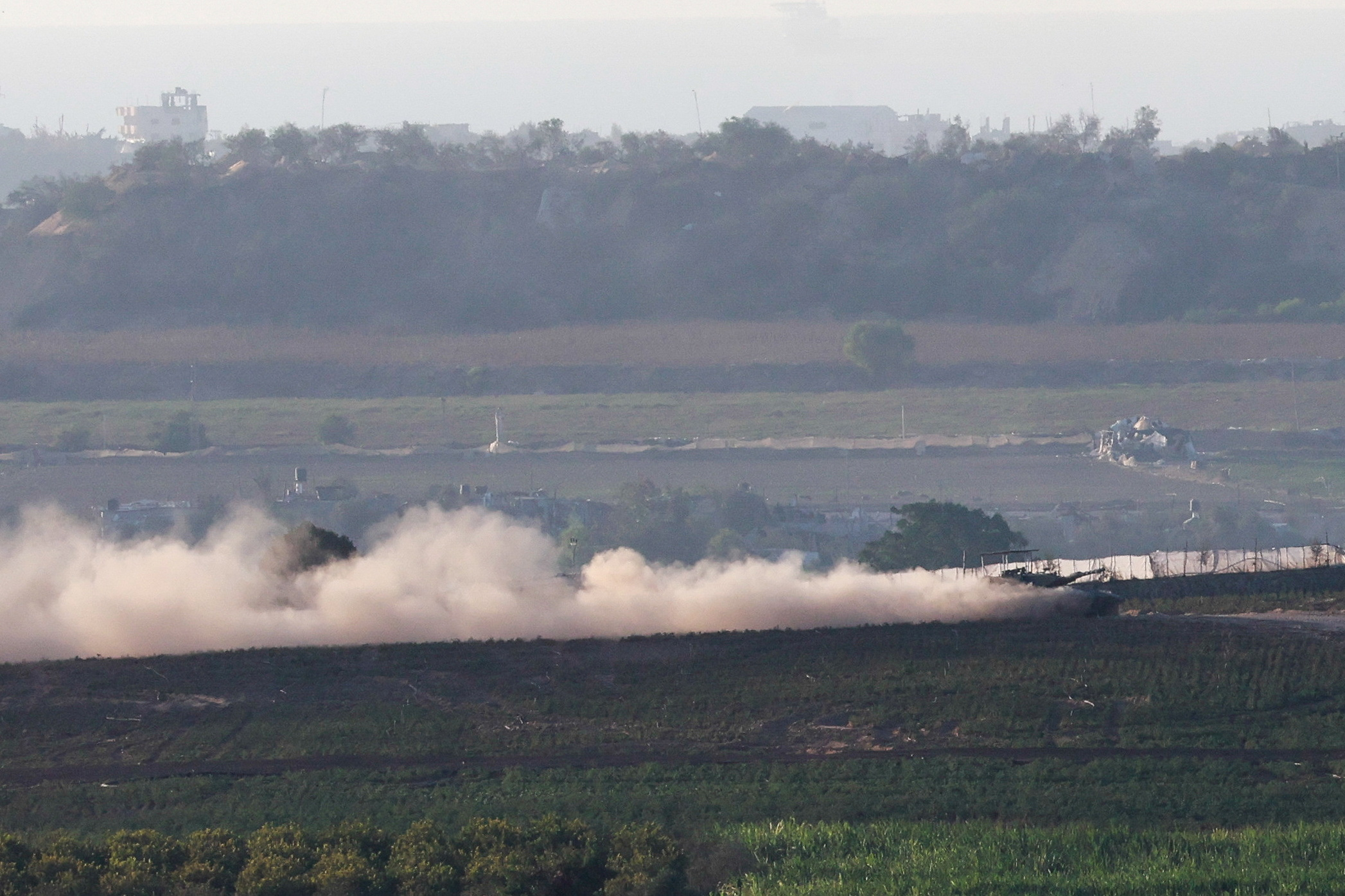 A tank manoeuvres at the border between Israel and the Gaza strip