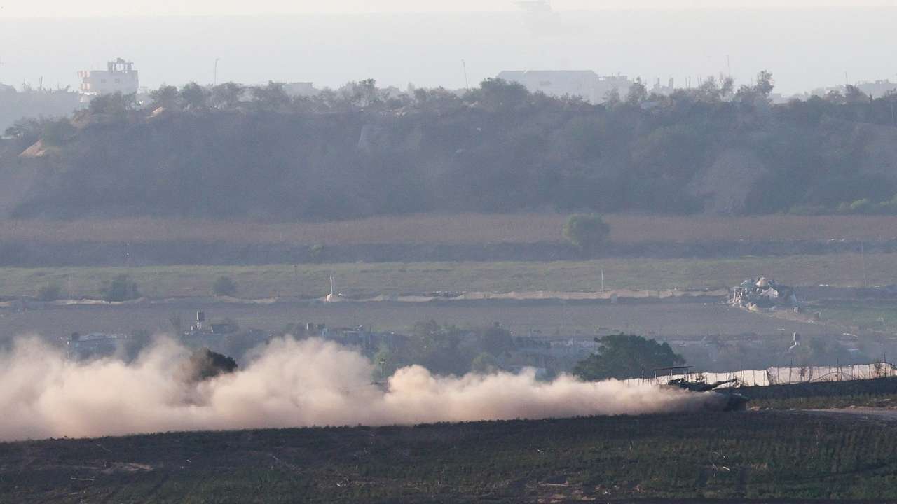 A tank manoeuvres at the border between Israel and the Gaza strip