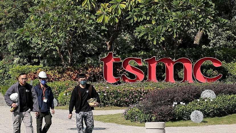 FILE PHOTO: People walk across the streets in front of TSMC Fab 18 at Southern Taiwan Science Park in Tainan
