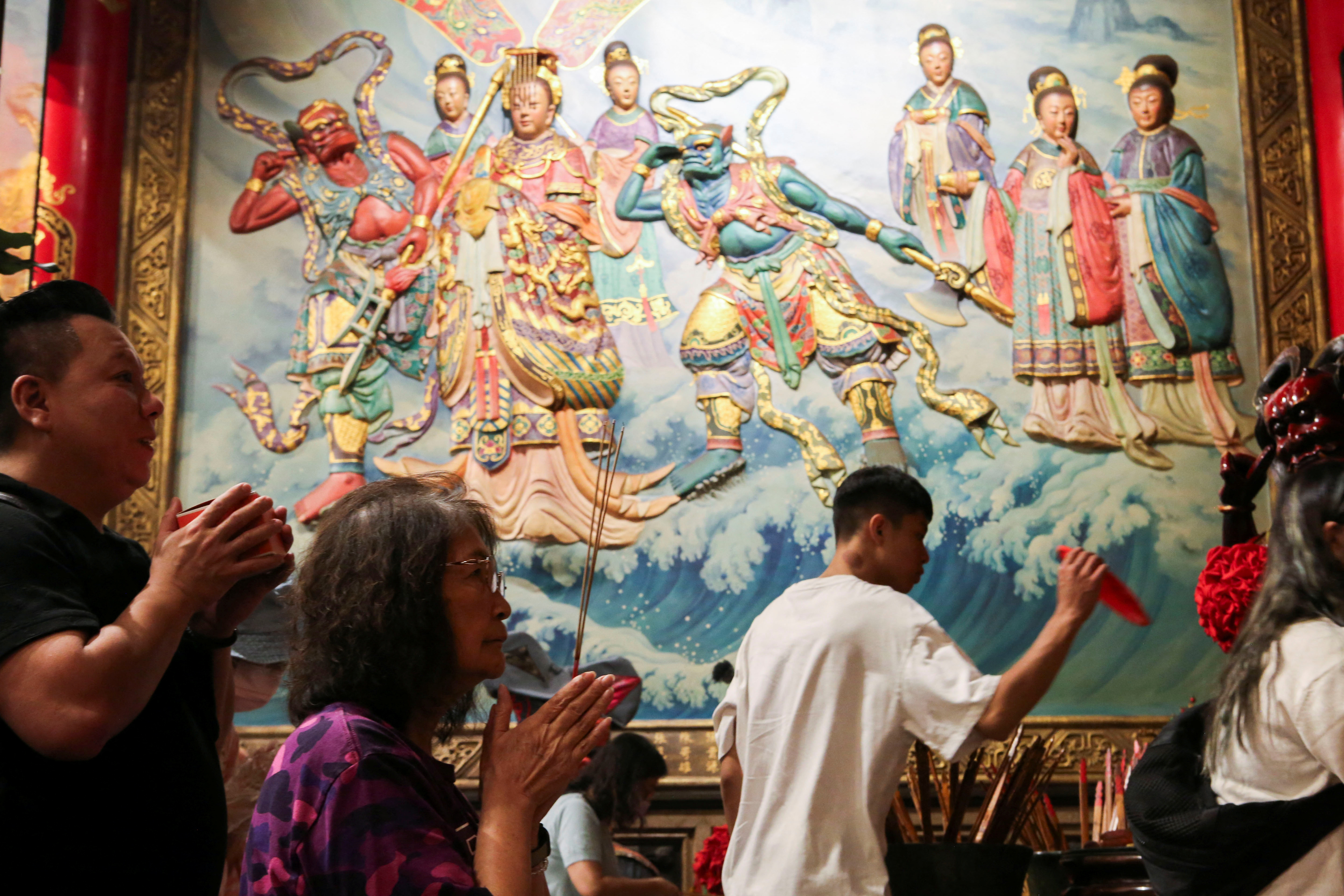 FILE PHOTO: Worshippers pray to the sea goddess Mazu at the Dajia Jenn Lann Temple in Dajia district of Taichung