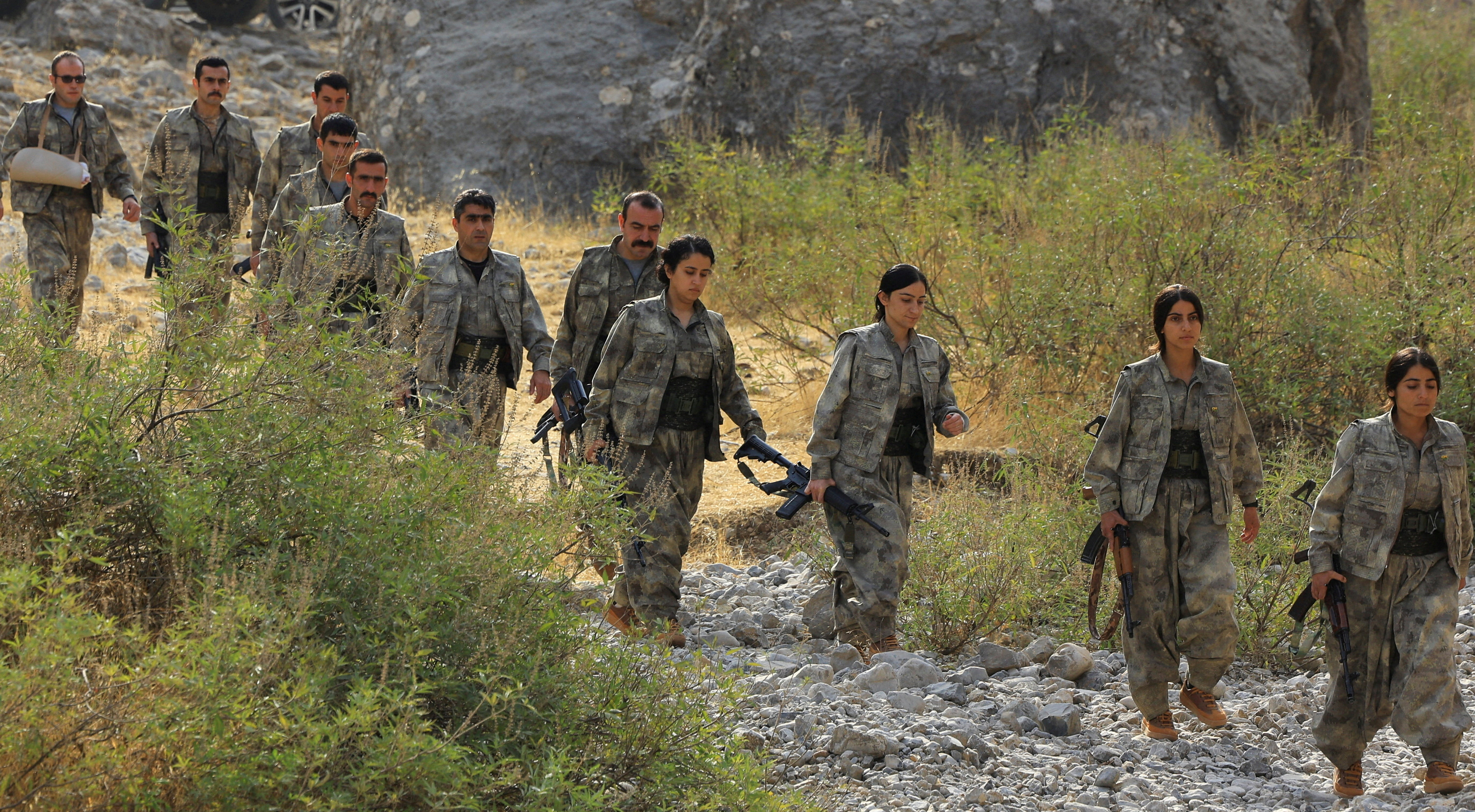 Fighters with the Kurdistan Workers' Party (PKK) walk for a disarmament ceremony in Qandil
