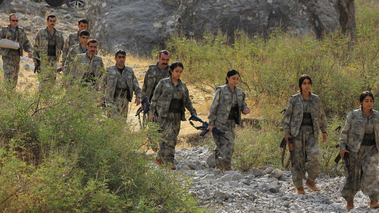 Fighters with the Kurdistan Workers' Party (PKK) walk for a disarmament ceremony in Qandil