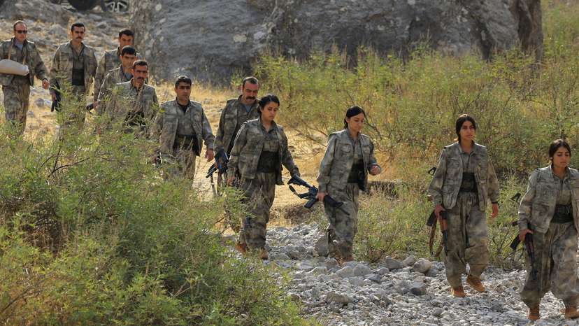 Fighters with the Kurdistan Workers' Party (PKK) walk for a disarmament ceremony in Qandil