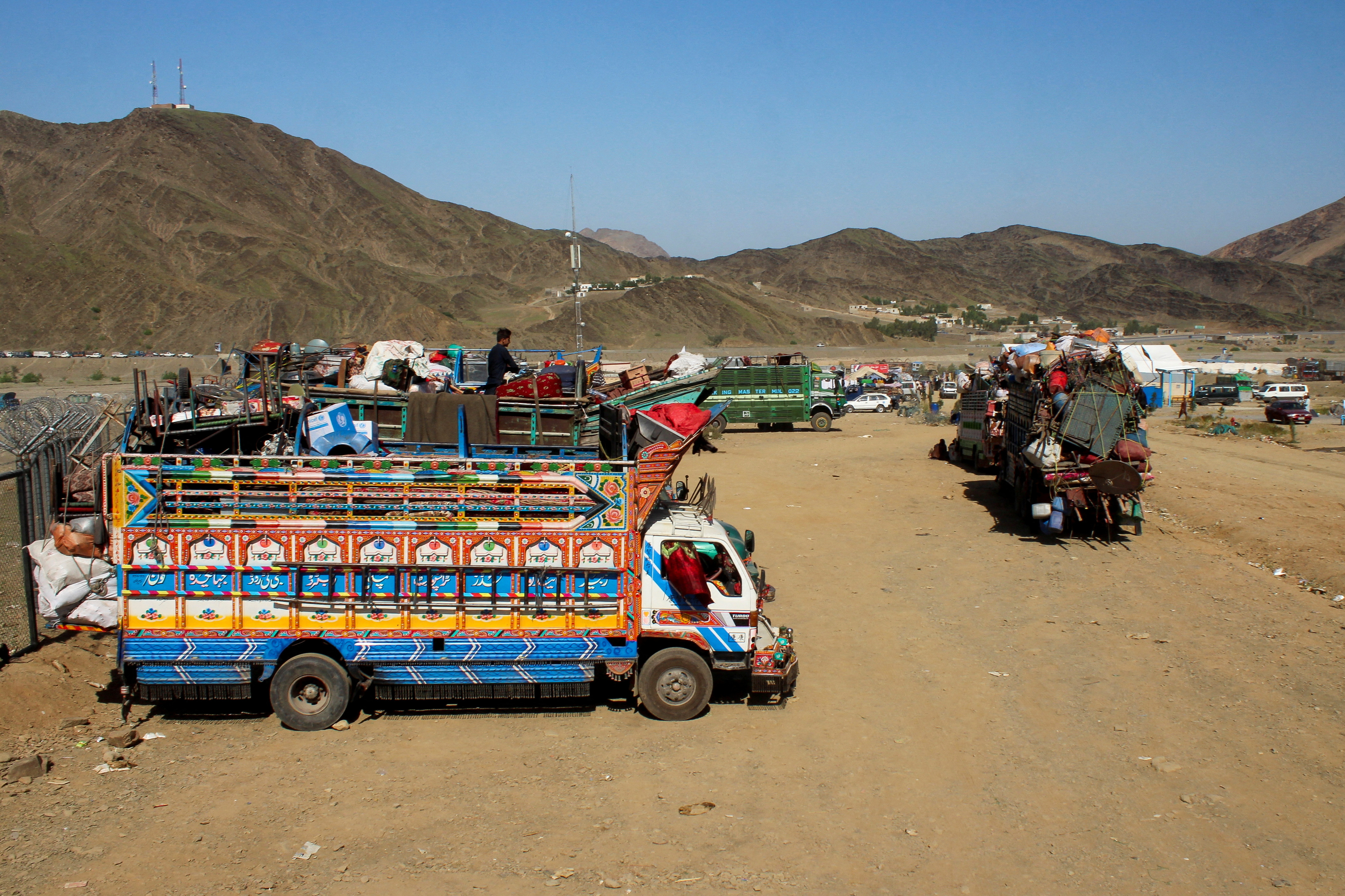 FILE PHOTO: Trucks transporting Afghan nationals who were expelled from Pakistan await registration at the Omari refugee camp in Mohmand Dara, Torkham border, Nangarhar province, Afghanistan
