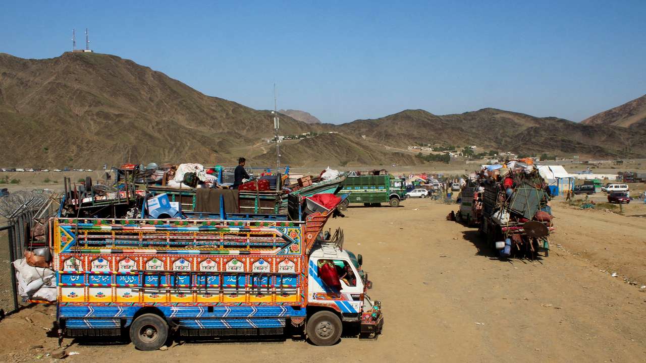 FILE PHOTO: Trucks transporting Afghan nationals who were expelled from Pakistan await registration at the Omari refugee camp in Mohmand Dara, Torkham border, Nangarhar province, Afghanistan