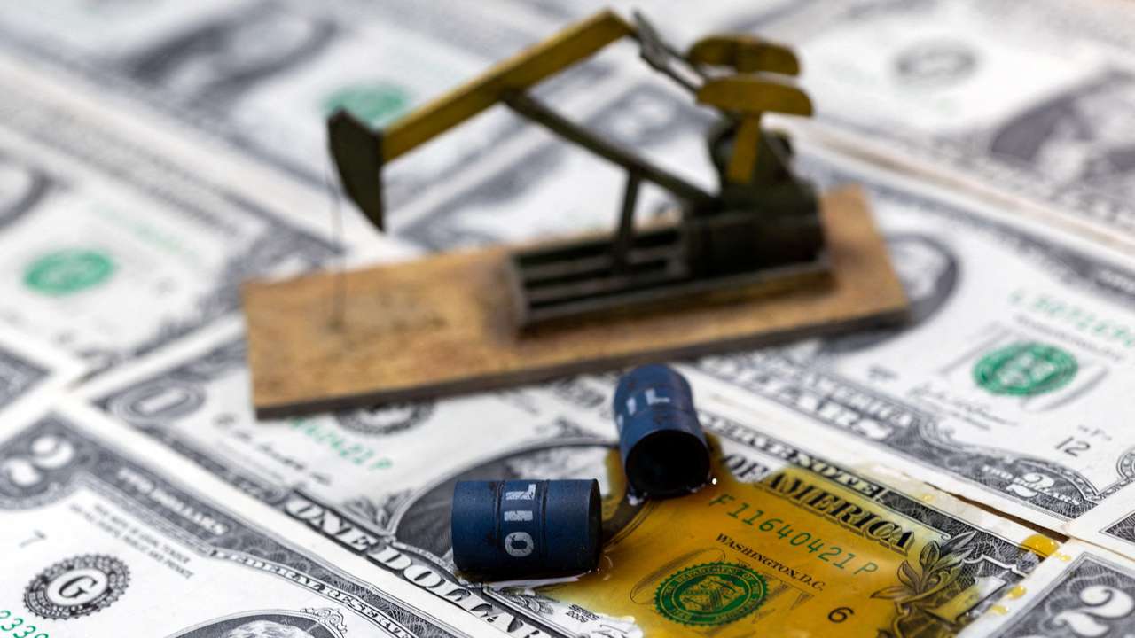 FILE PHOTO: Illustration shows oil, miniatures of oil barrels and U.S. dollar banknote