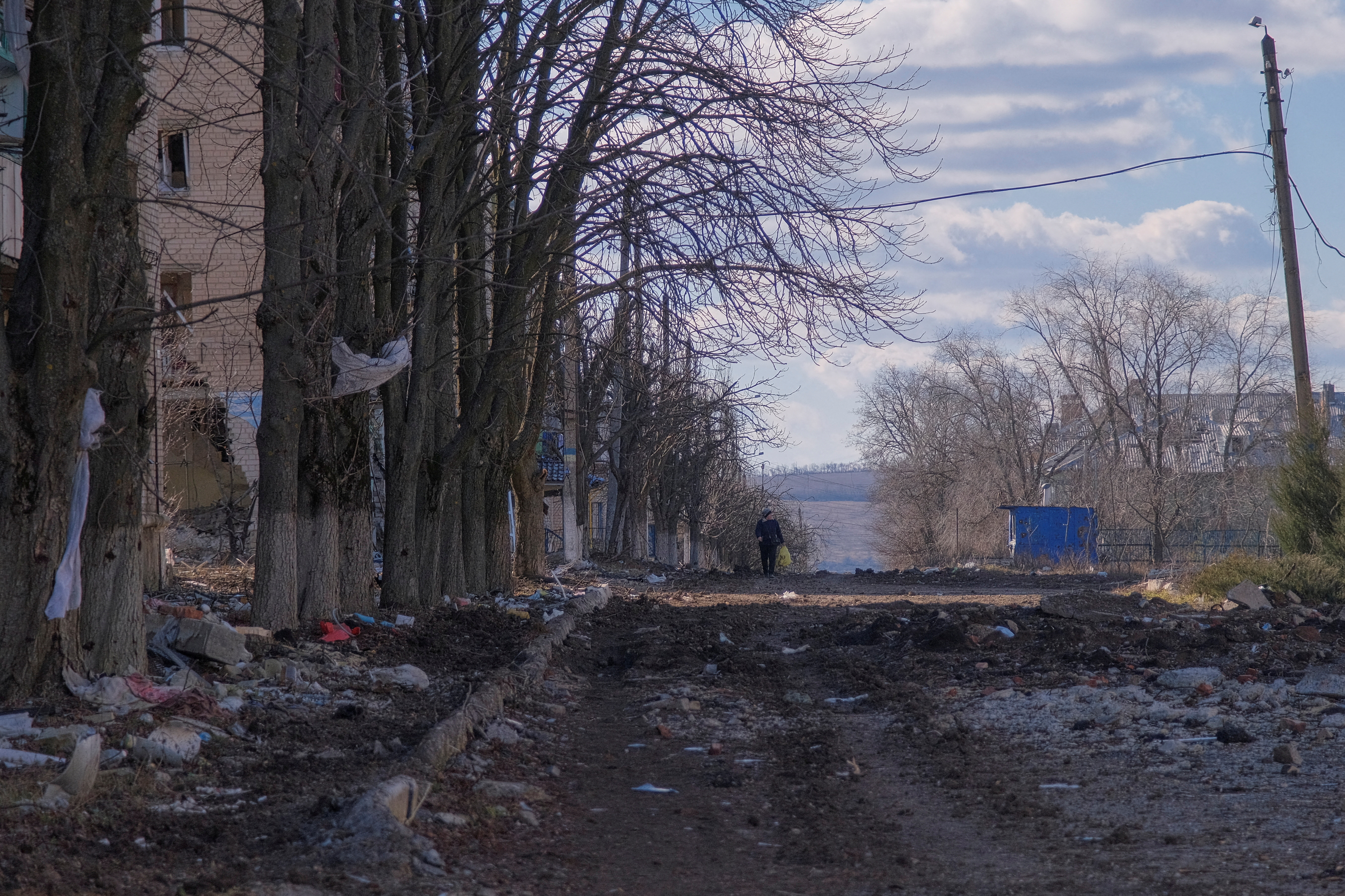 FILE PHOTO: Local resident walks along damaged street in the town of Siversk