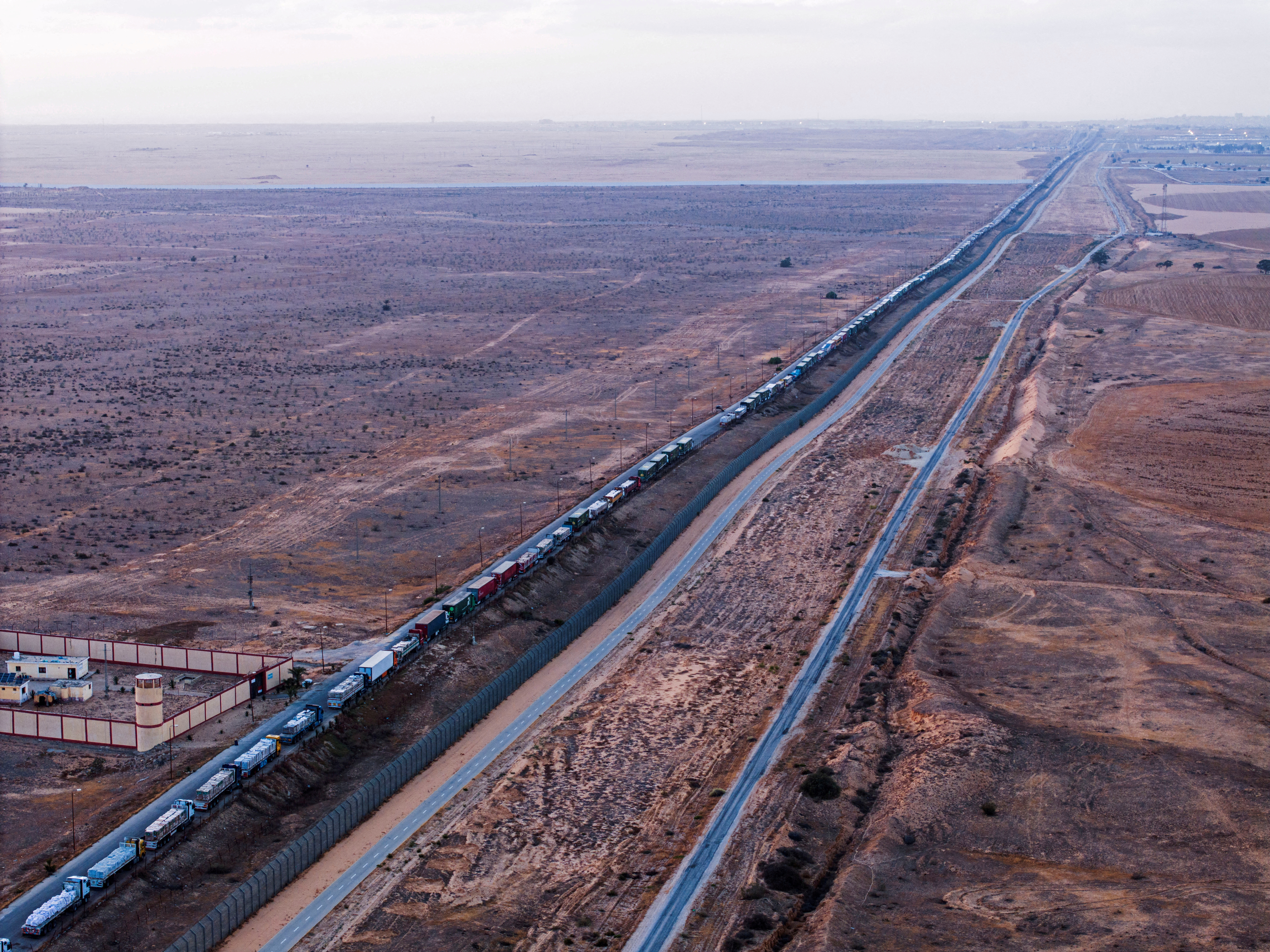 FILE PHOTO: A drone picture of a line of trucks waiting on an Egyptian road along the border with Israel, near the Rafah border crossing with the Gaza Strip
