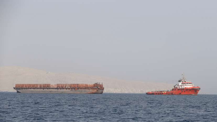 Tug boat moves cargo towards Strait of Hormuz, in Musandam province