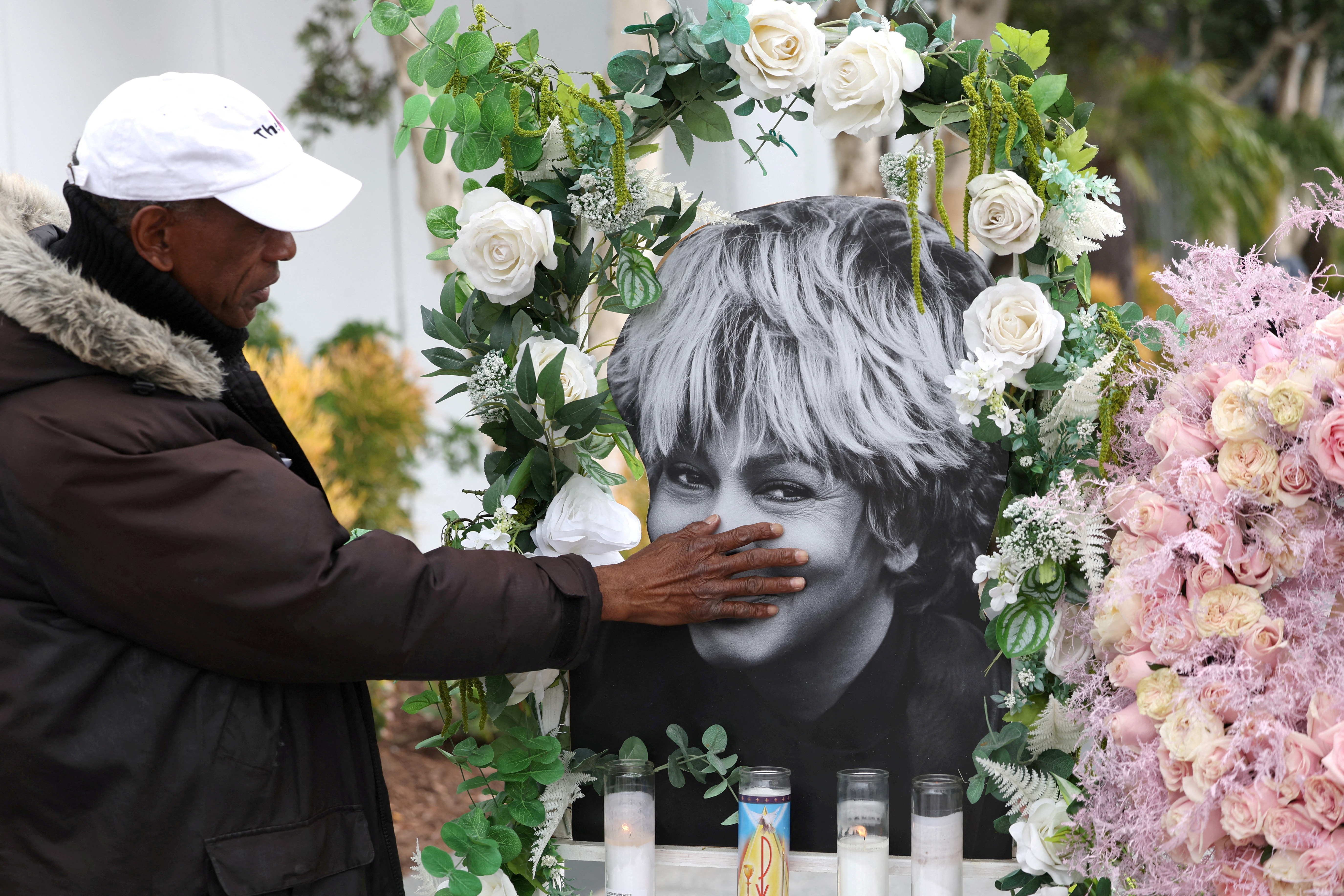 FILE PHOTO: Donnie Green touches a photograph of late singer Tina Turner placed near her star on the Hollywood Walk of Fame in Los Angeles