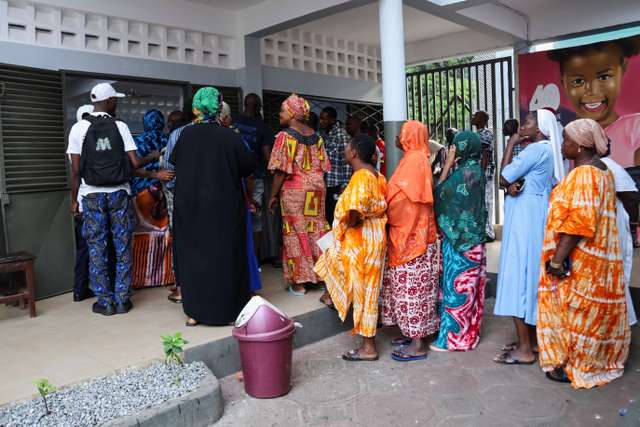 People wait to vote during the presidential election at a polling station in Conakry, Guinea December 28, 2025. REUTERS/ Souleymane Camara