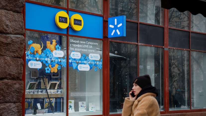 Woman talks on the phone in front of Kyivstar store in Kyiv