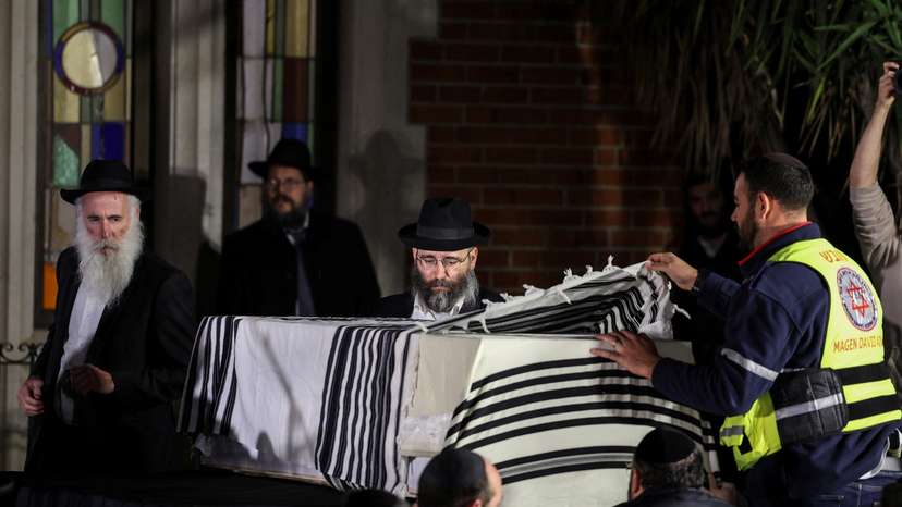 Mourners attend the funeral of Israeli rabbi, Zvi Kogan, in Kfar Habad