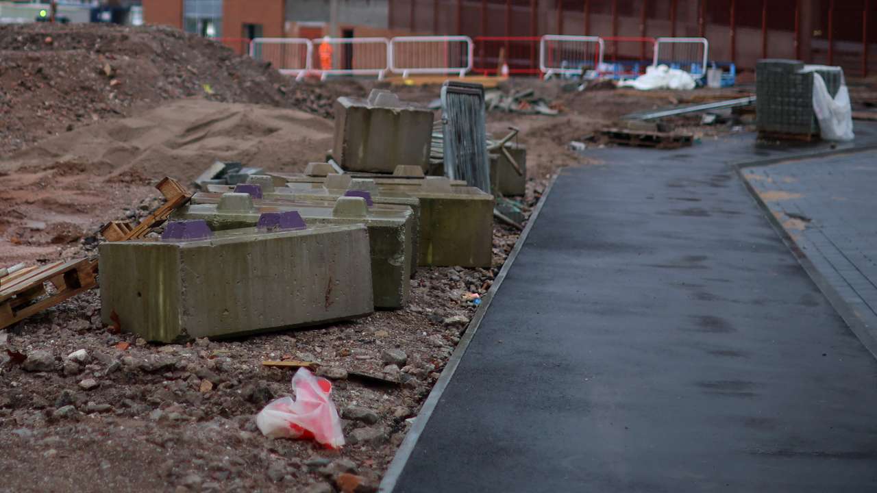 A strip of newly laid pavement sits next to a piece of undeveloped land on part of the Royal Arcade development in Crewe