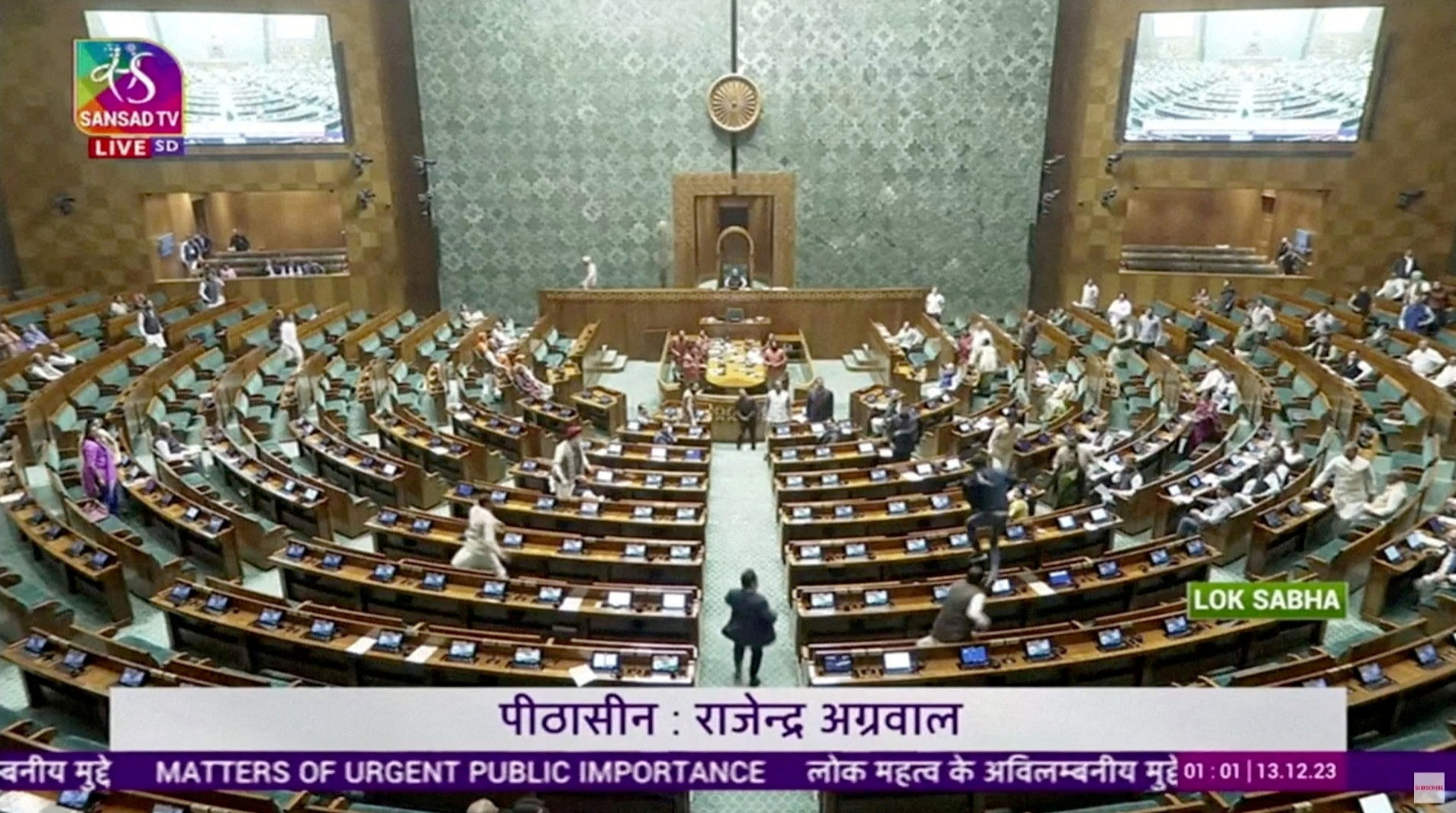 FILE PHOTO: A man jumps into lawmakers' area in the lower house of Indian Parliament, in New Delhi