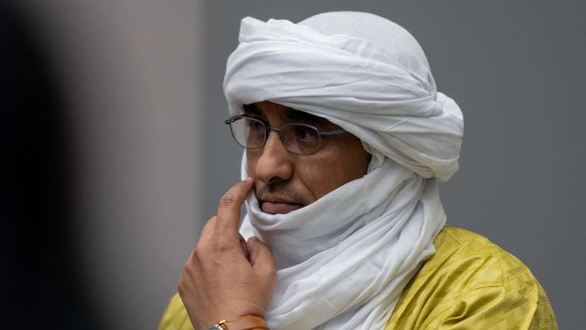 Al Hassan Ag Abdoul Aziz Ag Mohamed Ag Mahmoud rises as judges enter the courtroom of the International Criminal Court in The Hague