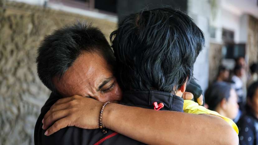 Kholil, 26, a survivor of KMP Tunu Pratama Jaya ferry sinking, reacts as he meets with his relative after a ferry carrying 65 people sank near the Indonesian island of Bali, at Gilimanuk port in Bali
