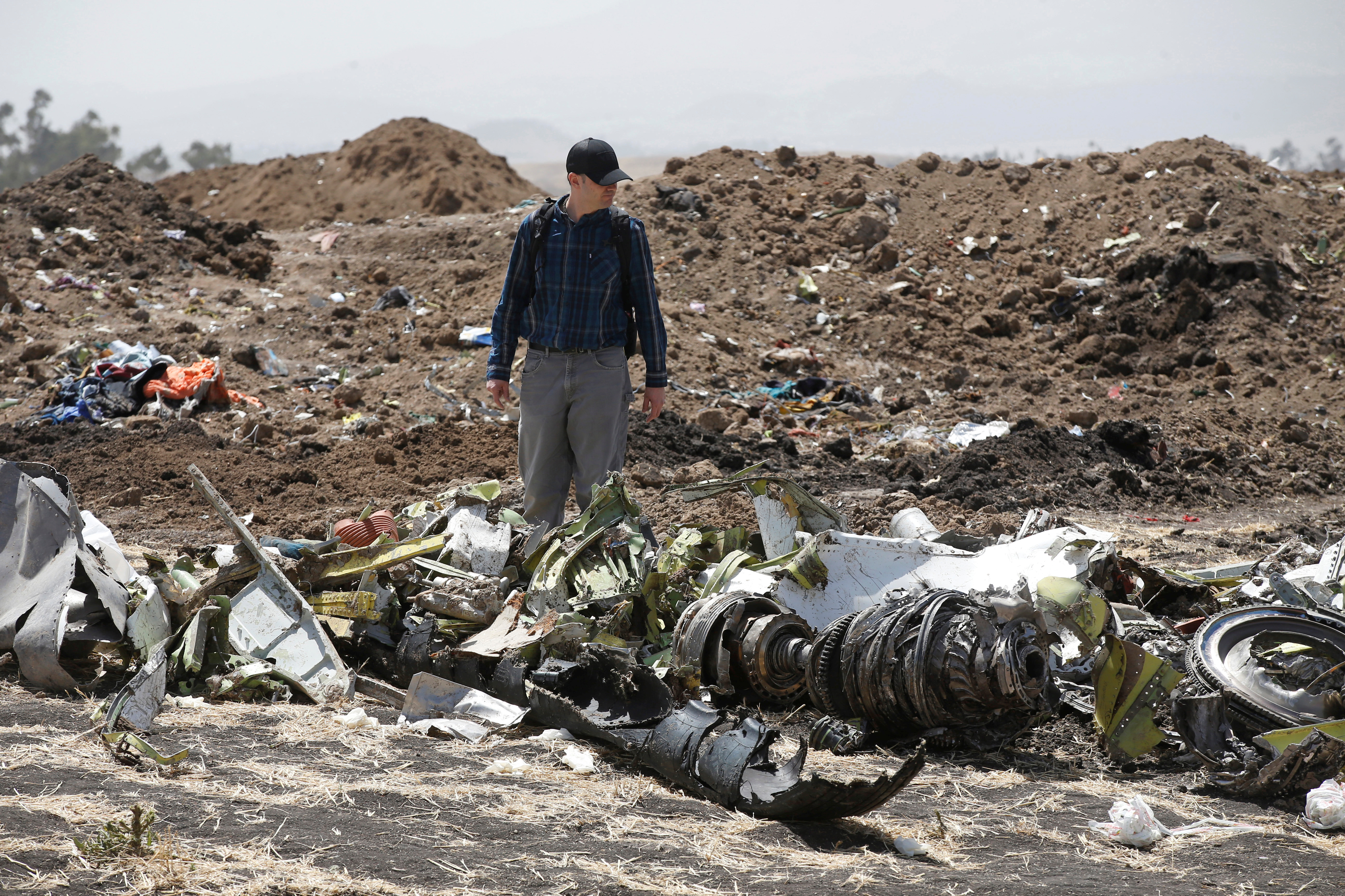 American civil aviation and Boeing investigators search through the debris at the scene of the Ethiopian Airlines Flight ET 302 plane crash, near the town of Bishoftu, southeast of Addis Ababa