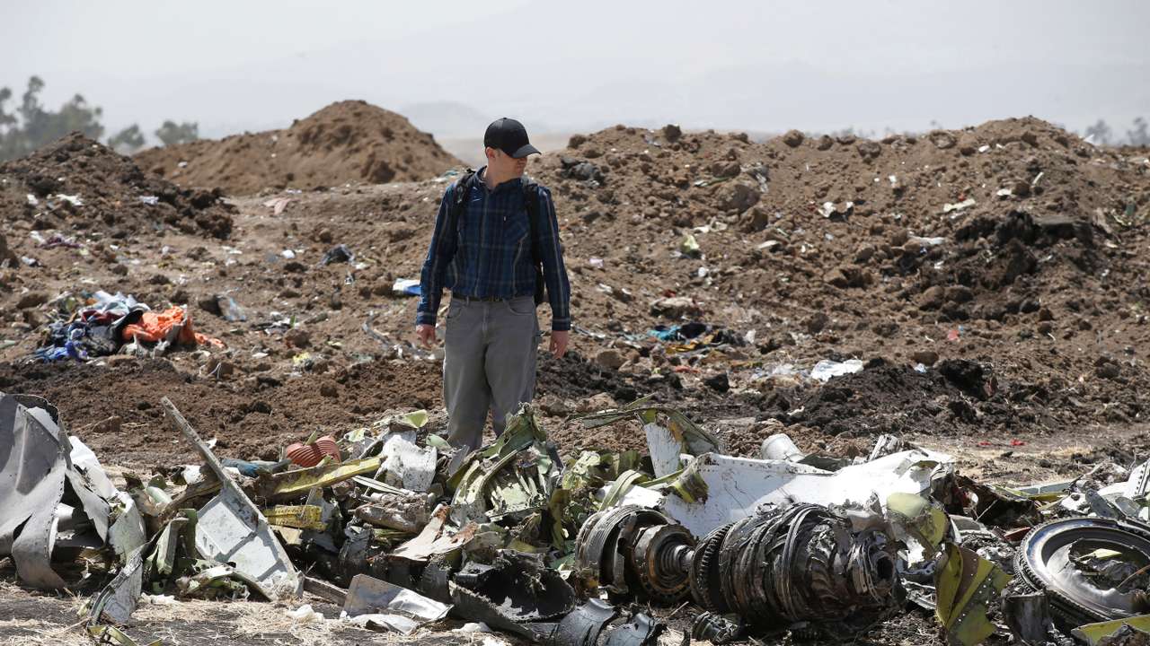 American civil aviation and Boeing investigators search through the debris at the scene of the Ethiopian Airlines Flight ET 302 plane crash, near the town of Bishoftu, southeast of Addis Ababa