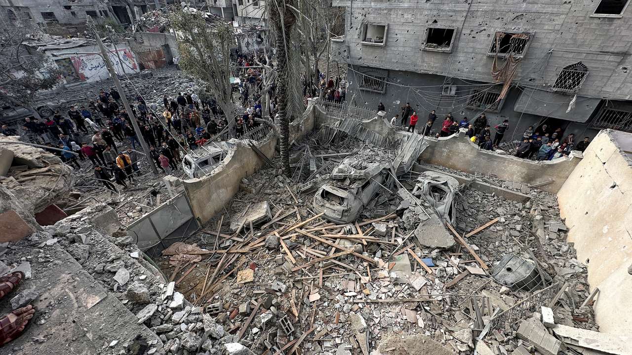 FILE PHOTO: Palestinians inspect the site of an Israeli strike on a house in Jabalia